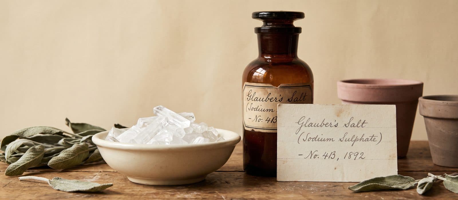 Clear Glauber's salt crystals in a small porcelain dish